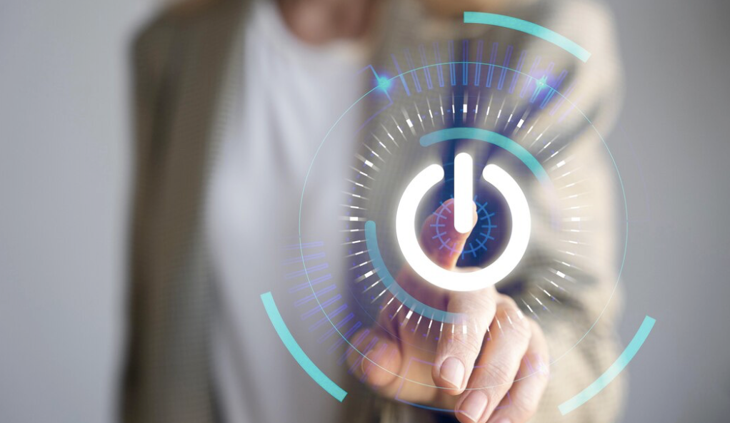 Weibliche Person berührt imaginaeren Power Button im Vordergrund
